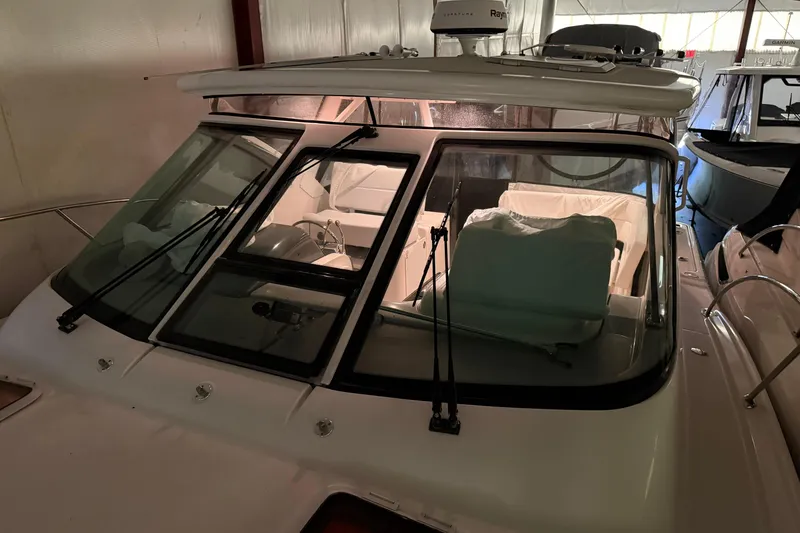 Slide: The Image of 2004 Tiara Yachts 3200 Open boat interior, featuring windshield and seating area. - 30