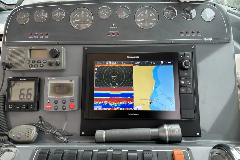 Slide: The Image of Dashboard of a 2004 Tiara Yachts 3200 Open with navigation and communication equipment. - 4