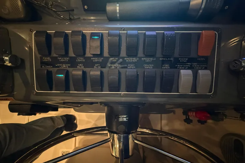 Slide: The Image of Control panel of a 2004 Tiara Yachts 3200 Open, featuring various switches and controls. - 9