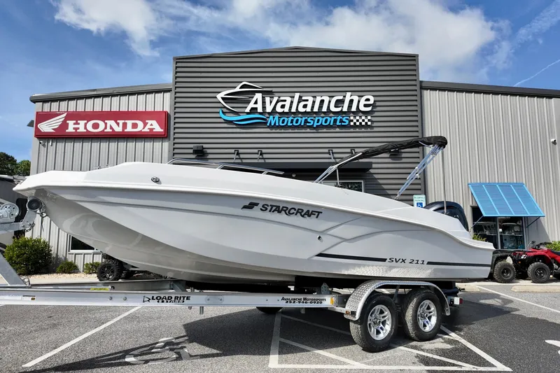 The Image of 2026 Starcraft SVX 211 OB boat on trailer at Avalanche Motorsports dealership. - 0