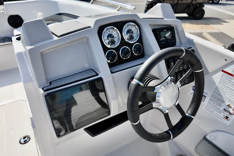 Slide: The Image of 2026 Starcraft SVX 211 OB boat dashboard with steering wheel and gauges. - 11