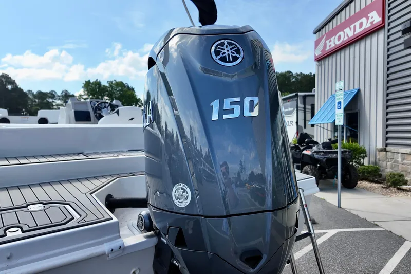 Slide: The Image of 2026 Starcraft SVX 211 OB boat with Yamaha 150 outboard motor at dealership. - 4