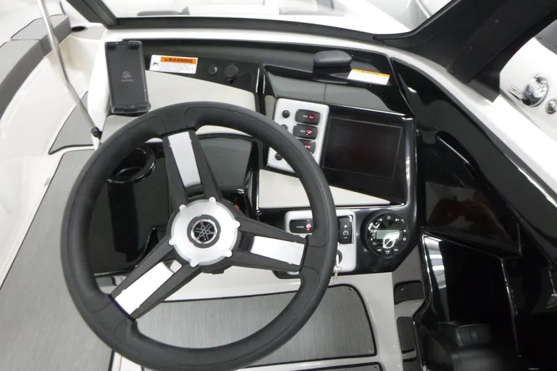 Slide: The Image of 2026 Yamaha Boats AR220 dashboard with steering wheel and control panel. - 13