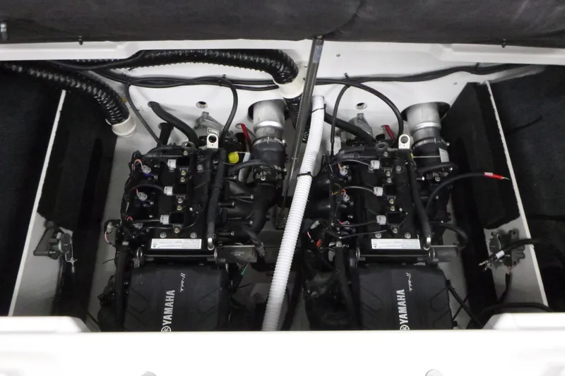 Slide: The Image of Engine compartment of 2026 Yamaha Boats AR220, showcasing dual engines and wiring. - 16