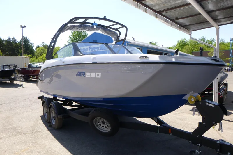 Slide: The Image of 2026 Yamaha Boats AR220 on trailer, parked outdoors under a canopy. - 3