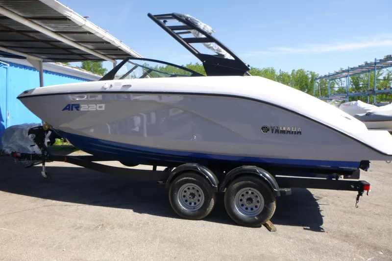 Slide: The Image of 2026 Yamaha Boats AR220 on trailer, parked outdoors under a canopy. - 4