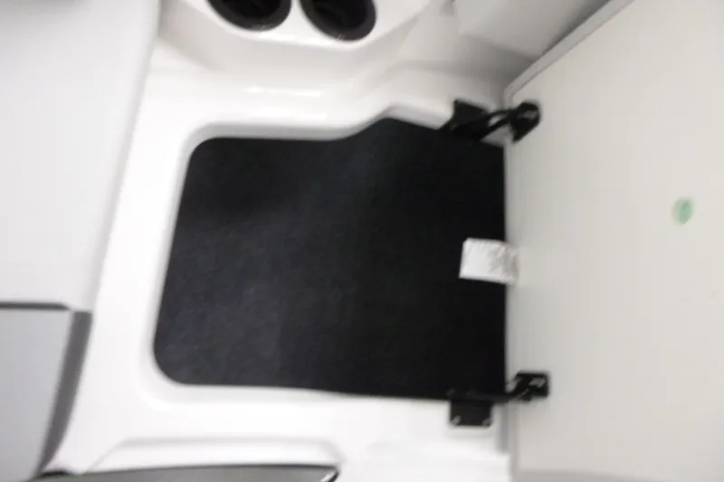 Slide: The Image of Interior view of 2026 Yamaha Boats AR220, featuring a black mat and cup holders. - 9