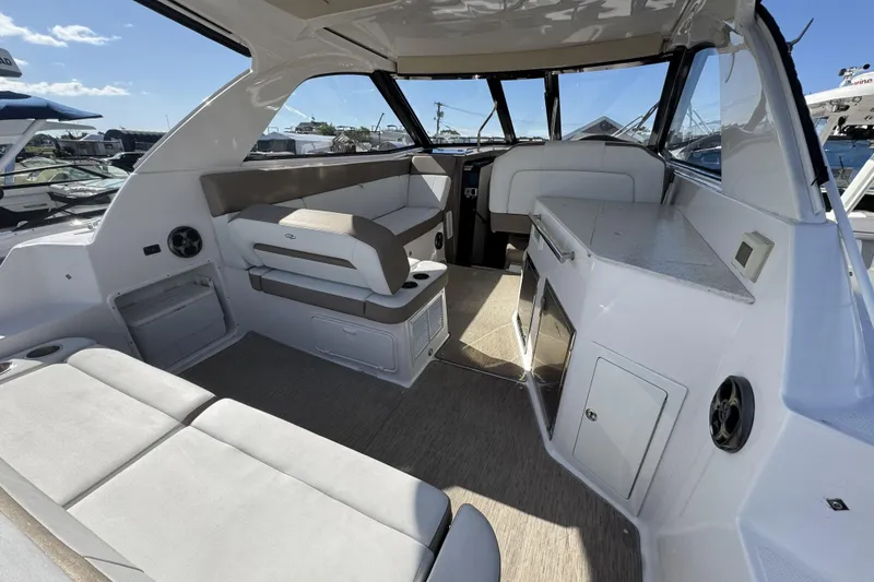 Slide: The Image of Interior of a 2016 Regal 35 Sport Coupe boat with spacious seating and modern design. - 10