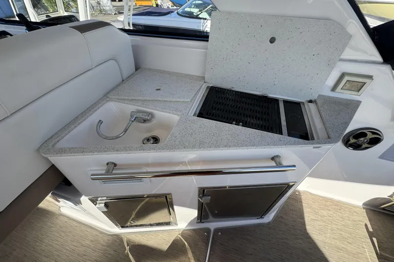 Slide: The Image of 2016 Regal 35 Sport Coupe boat interior with sink and grill station. - 11