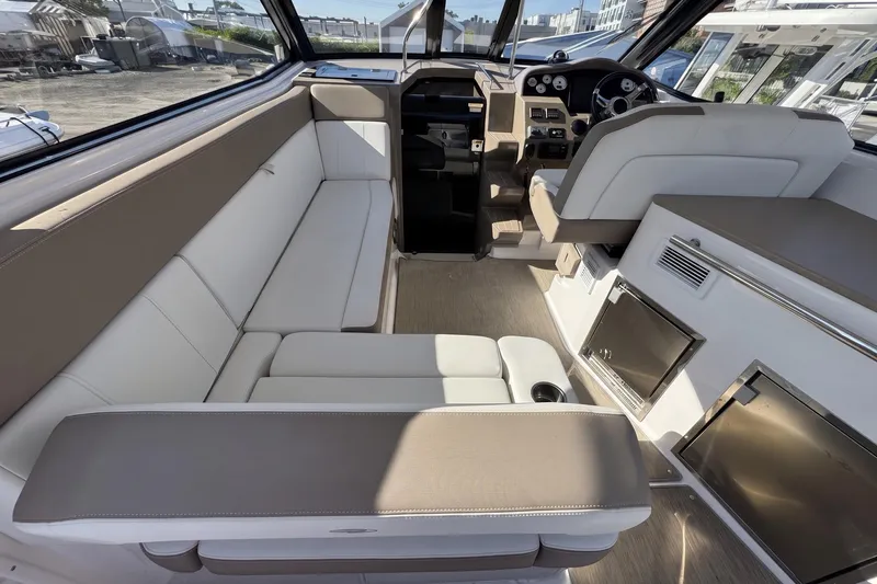 Slide: The Image of Interior of a 2016 Regal 35 Sport Coupe with beige seating and modern dashboard. - 12