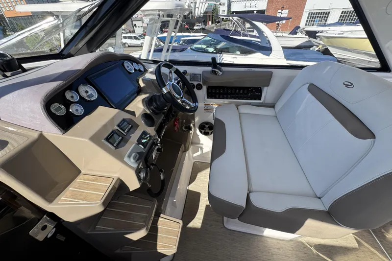 Slide: The Image of Cockpit of 2016 Regal 35 Sport Coupe with modern controls and comfortable seating. - 13