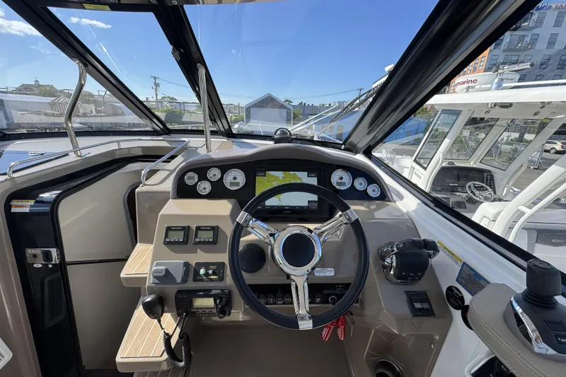 Slide: The Image of 2016 Regal 35 Sport Coupe cockpit with steering wheel and navigation controls. - 15