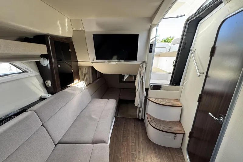 Slide: The Image of Interior of 2016 Regal 35 Sport Coupe with modern seating and mounted TV. - 16