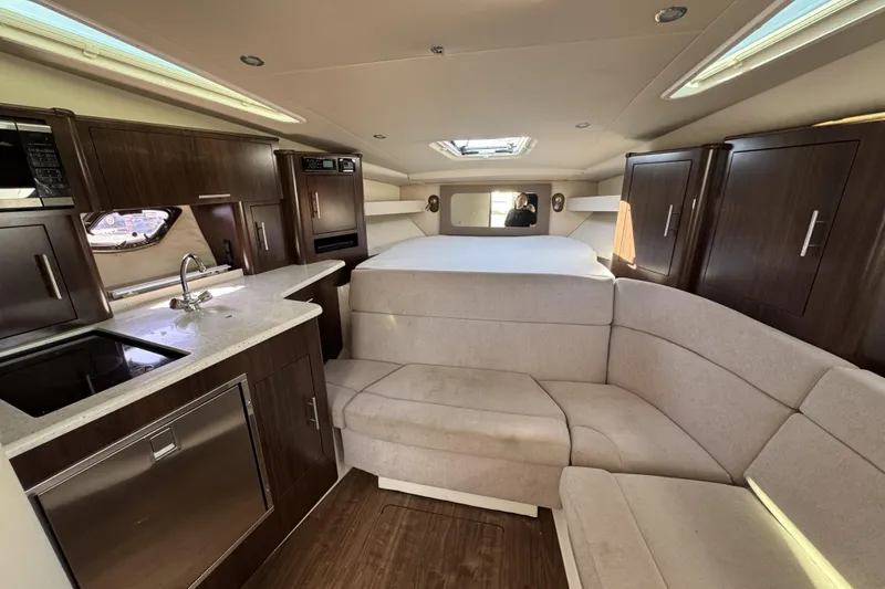 Slide: The Image of Interior of 2016 Regal 35 Sport Coupe with modern kitchen and cozy seating area. - 18