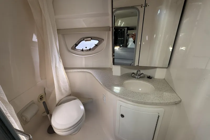 Slide: The Image of Bathroom interior of 2016 Regal 35 Sport Coupe with sink, toilet, and porthole window. - 20