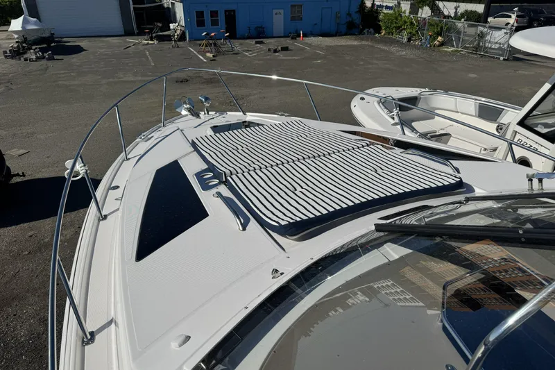 Slide: The Image of 2016 Regal 35 Sport Coupe boat with striped sun pad on deck. - 21