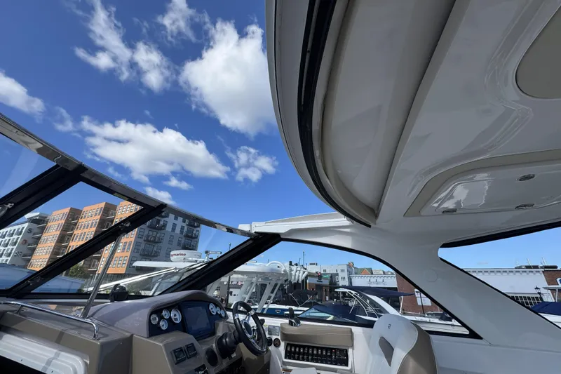 Slide: The Image of Interior view of a 2016 Regal 35 Sport Coupe yacht under a clear blue sky. - 24