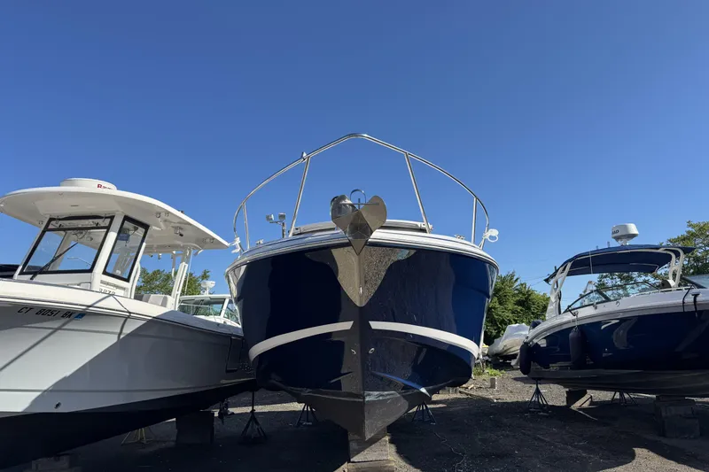 Slide: The Image of 2016 Regal 35 Sport Coupe boat on display under clear blue sky. - 3