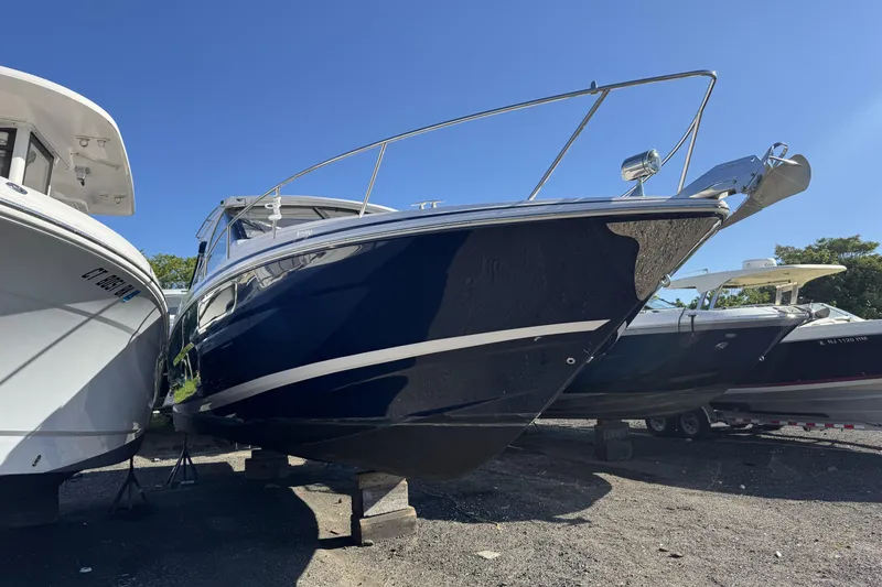 Slide: The Image of 2016 Regal 35 Sport Coupe boat on display under clear blue sky. - 4