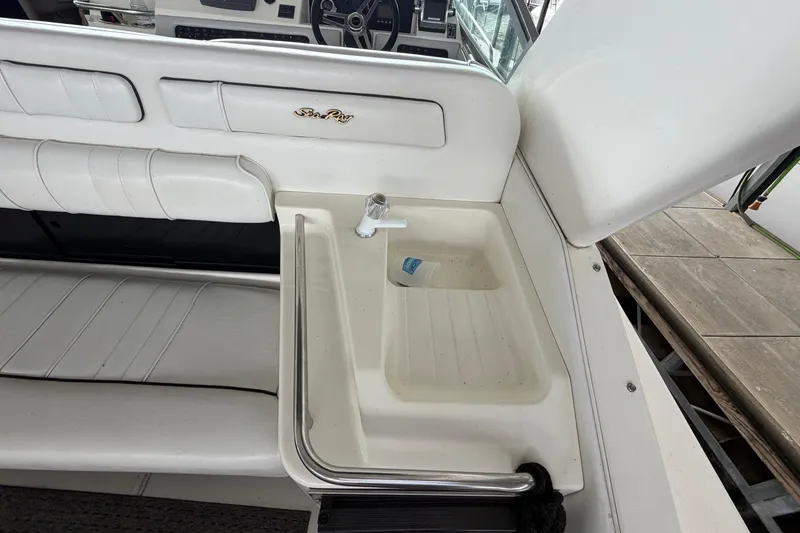 Slide: The Image of 1994 Sea Ray Sundancer 330 boat interior with sink and seating area. - 10