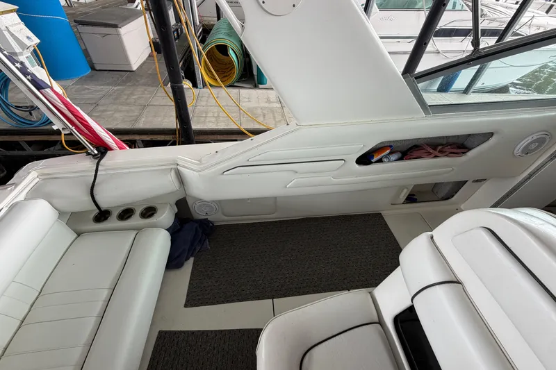 Slide: The Image of Interior of a 1994 Sea Ray Sundancer 330 boat with white seating and storage compartments. - 11