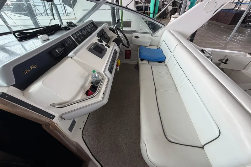 Slide: The Image of 1994 Sea Ray Sundancer 330 cockpit with white seating and control panel. - 12