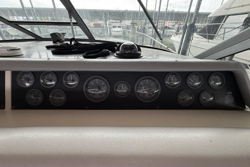 Slide: The Image of Dashboard of a 1994 Sea Ray Sundancer 330 boat with multiple gauges and controls. - 15