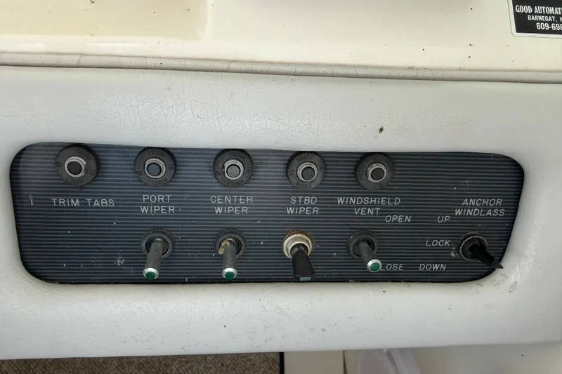 Slide: The Image of Control panel of a 1994 Sea Ray Sundancer 330 boat with various switches. - 17