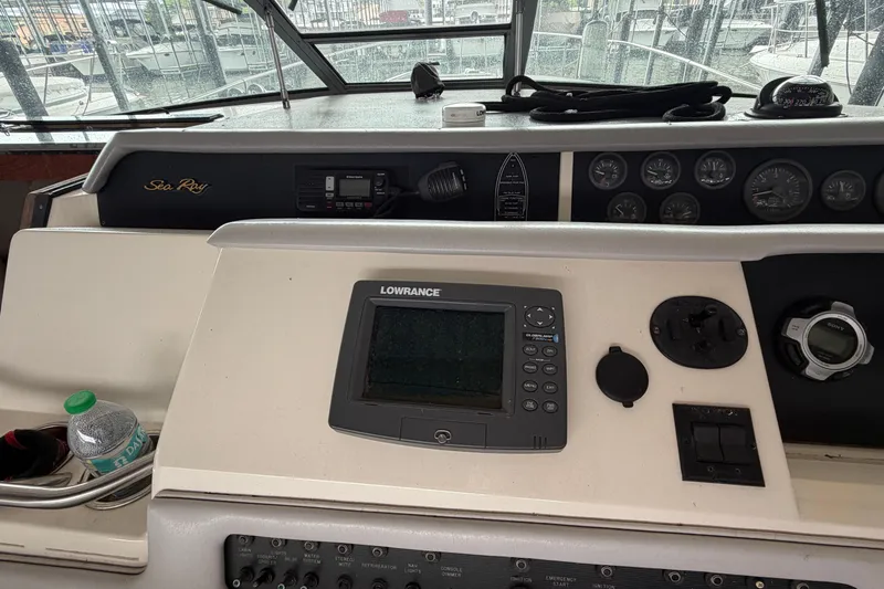 Slide: The Image of 1994 Sea Ray Sundancer 330 helm with Lowrance navigation system and control panel. - 20