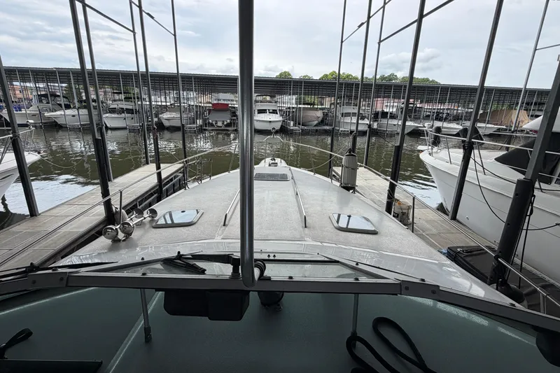 Slide: The Image of 1994 Sea Ray Sundancer 330 docked in a marina with multiple boats. - 21