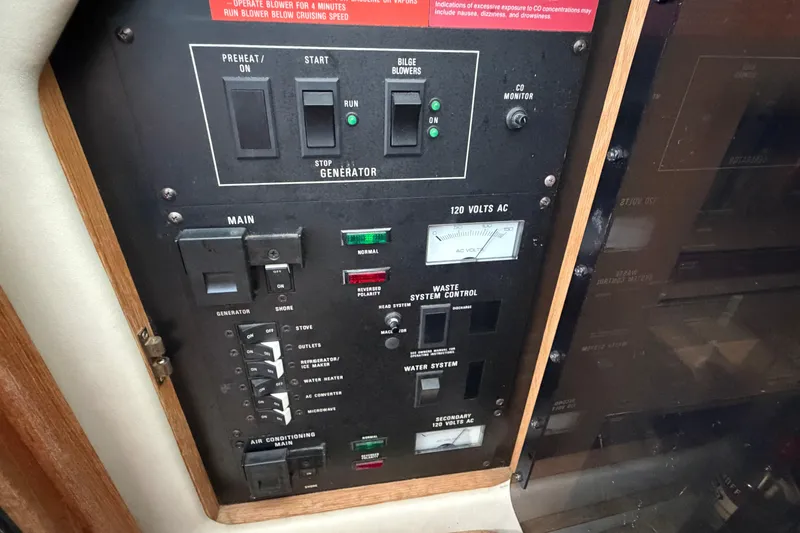 Slide: The Image of Control panel of a 1994 Sea Ray Sundancer 330 boat, featuring generator and electrical switches. - 25