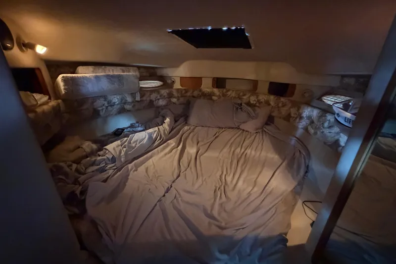 Slide: The Image of Cozy cabin interior of 1994 Sea Ray Sundancer 330 with bed and soft lighting. - 26