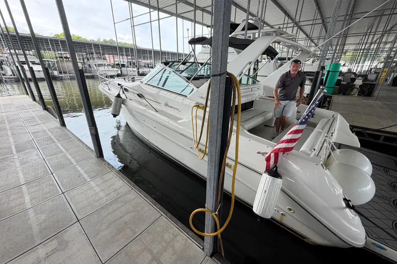 Slide: The Image of Man on 1994 Sea Ray Sundancer 330 boat docked in marina with American flag. - 3