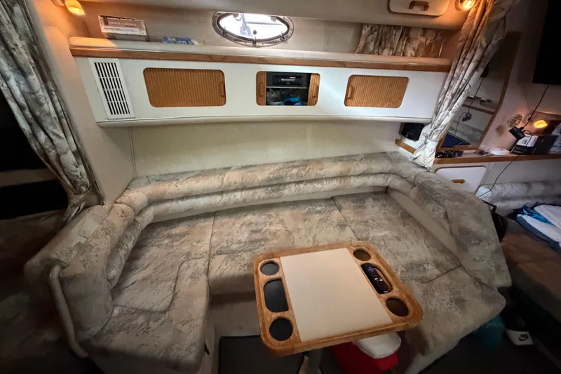 Slide: The Image of Interior of a 1994 Sea Ray Sundancer 330 with cozy seating and wooden accents. - 30