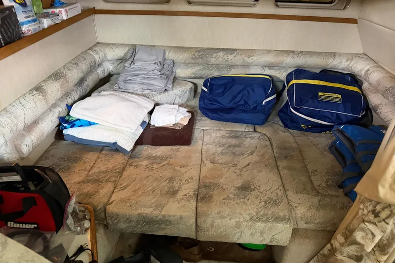 Slide: The Image of Interior cabin of a 1994 Sea Ray Sundancer 330 with seating and storage bags. - 32