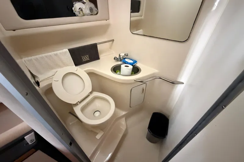 Slide: The Image of Bathroom interior of 1994 Sea Ray Sundancer 330 yacht, featuring toilet and sink. - 33