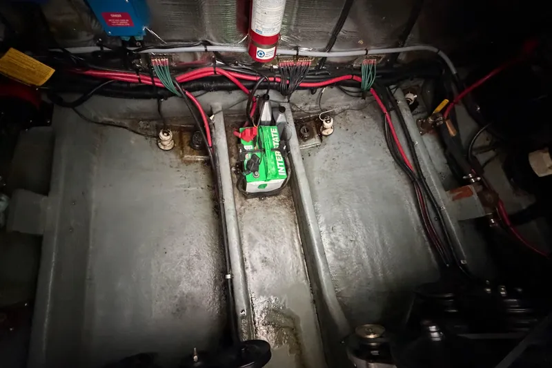 Slide: The Image of Engine compartment of a 1994 Sea Ray Sundancer 330 with visible wiring and battery. - 37