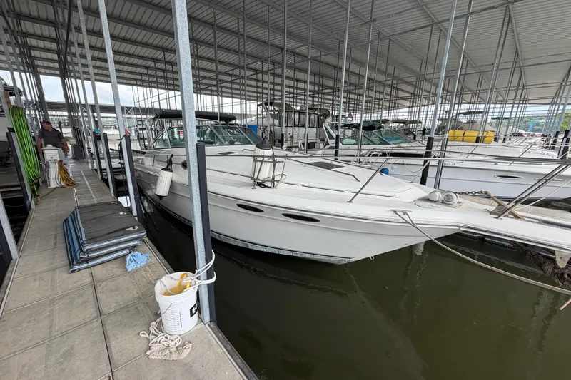 Slide: The Image of 1994 Sea Ray Sundancer 330 docked in a covered marina. - 4