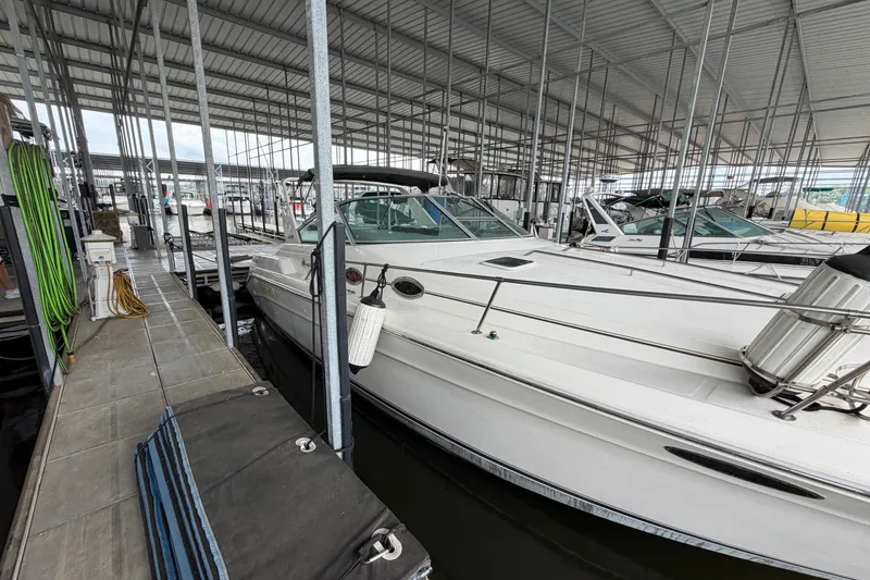 Slide: The Image of 1994 Sea Ray Sundancer 330 docked in a covered marina, side view. - 5