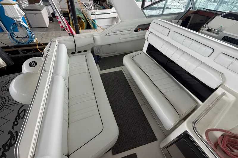 Slide: The Image of Interior of a 1994 Sea Ray Sundancer 330 with white seating and nautical equipment. - 8