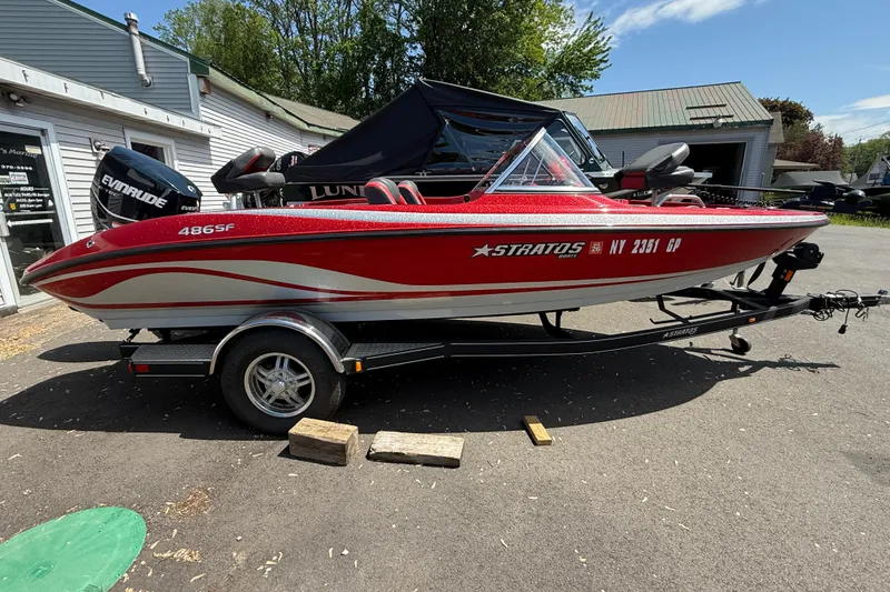 Slide: The Image of 2013 Stratos 486 Ski-N-Fish boat on trailer, red and silver design, parked outdoors. - 11