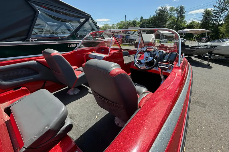 Slide: The Image of Red 2013 Stratos 486 Ski-N-Fish boat interior with steering wheel and seating. - 12