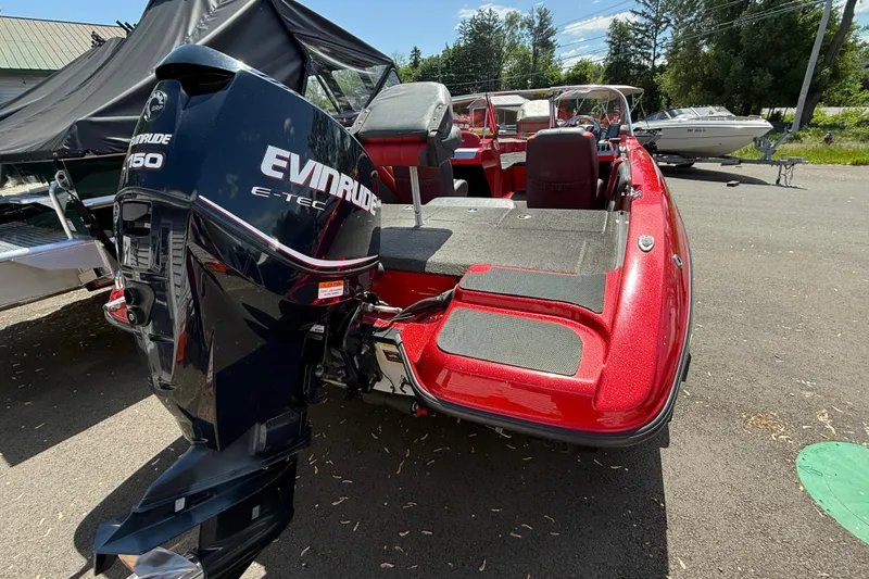 Slide: The Image of 2013 Stratos 486 Ski-N-Fish boat with Evinrude 150 E-TEC engine, parked outdoors. - 13