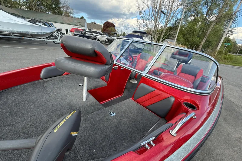 Slide: The Image of 2013 Stratos 486 Ski-N-Fish boat with red and black interior, parked outdoors. - 16