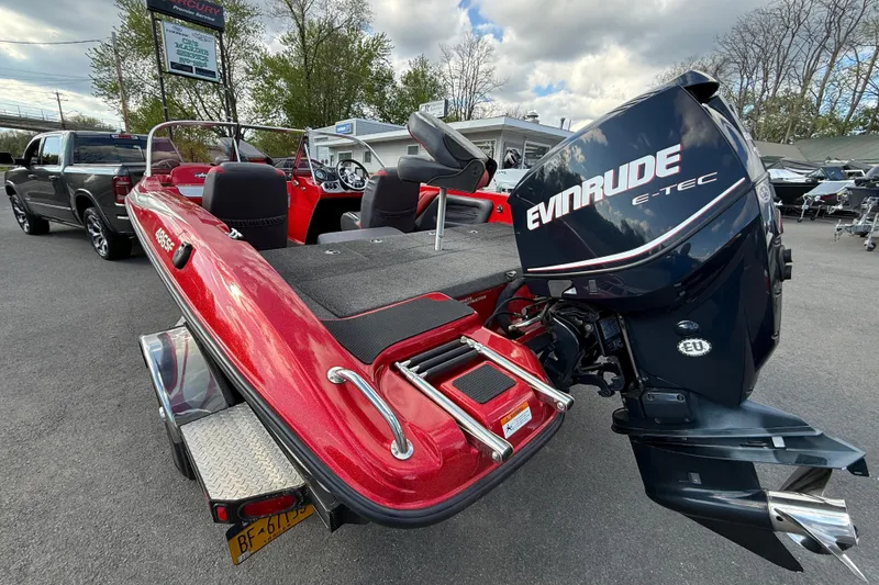 Slide: The Image of Red 2013 Stratos 486 Ski-N-Fish boat with Evinrude E-TEC engine in parking lot. - 17