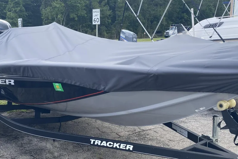 Slide: The Image of 2020 Tracker Pro Team 175 TXW boat covered on trailer, parked near speed limit sign. - 3