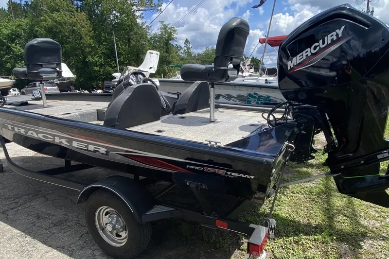 Slide: The Image of 2020 Tracker Pro Team 175 TXW boat with Mercury engine, parked outdoors. - 5