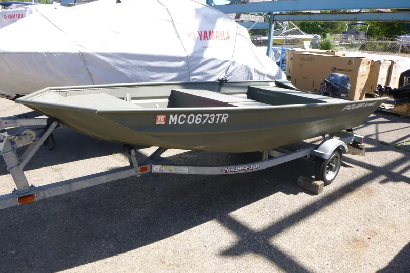 The Image of 2014 Polar Kraft Jon MV 1448 LW boat on trailer, parked outdoors. - 1