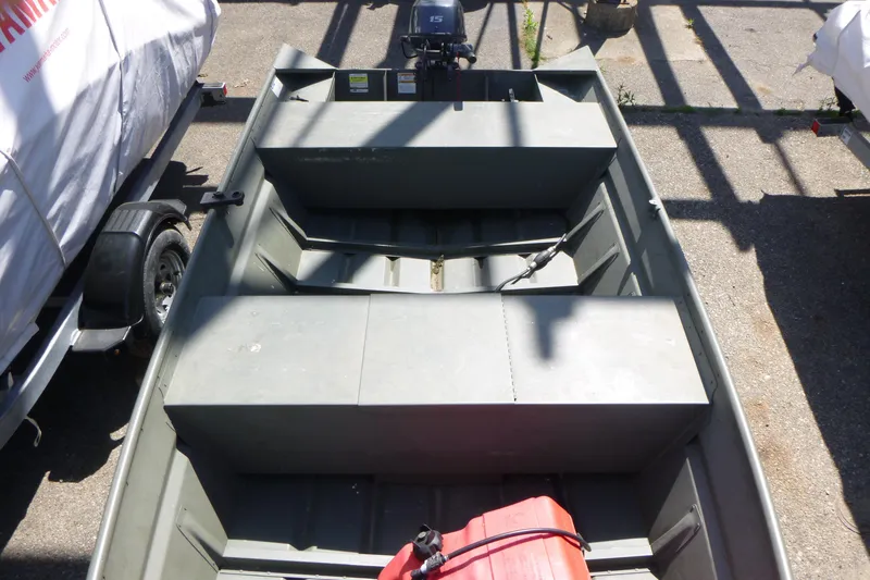 Slide: The Image of 2014 Polar Kraft Jon MV 1448 LW boat with motor, parked on pavement. - 4