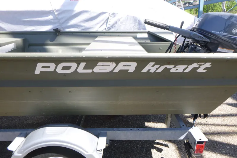 Slide: The Image of 2014 Polar Kraft Jon MV 1448 LW boat on trailer, featuring outboard motor. - 7